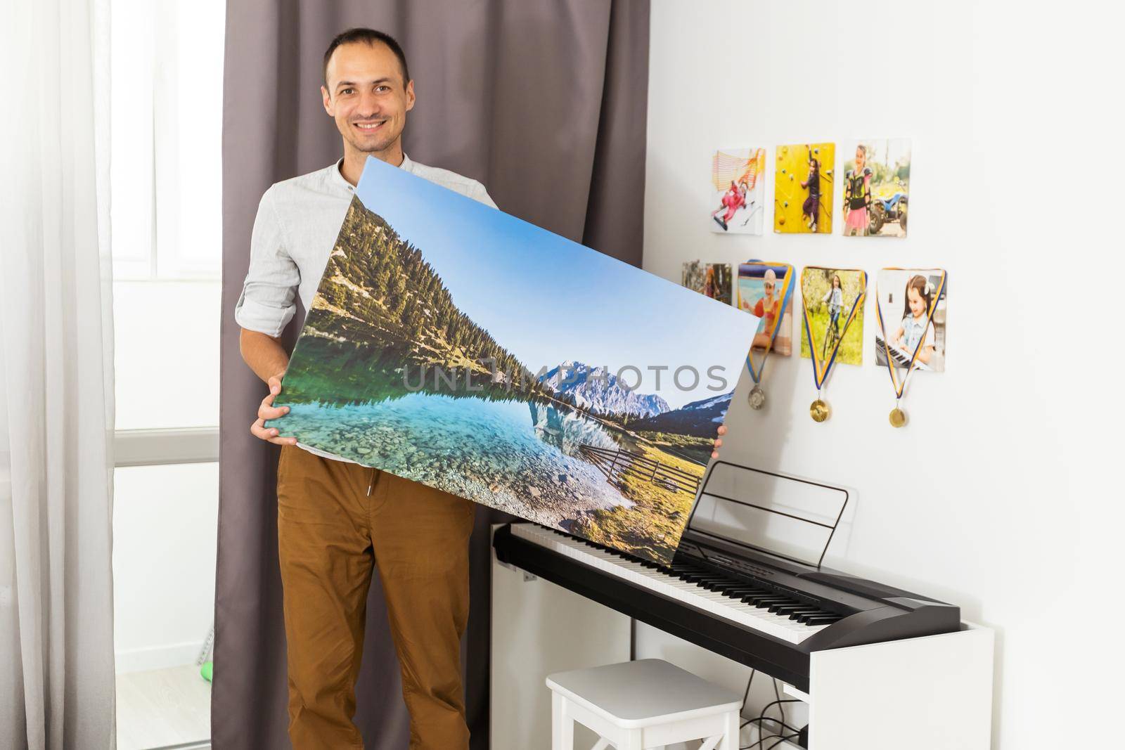 Modern Home Interior And Domestic Decor. a man is holding a photo canvas.