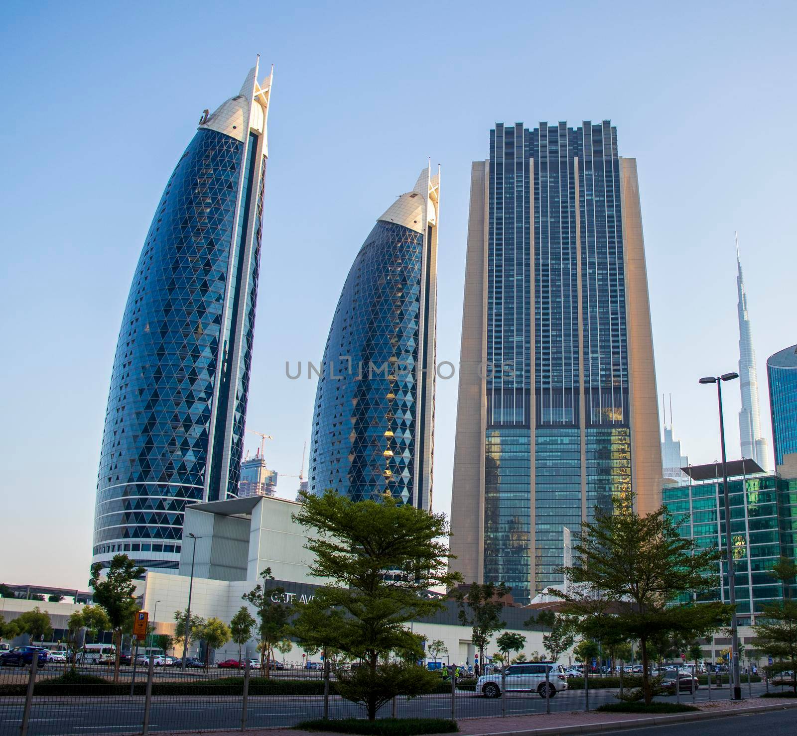 Dubai Financial Center road. Landmarks such Burj Khalifa, tallest building in the world, Index tower, Park towers can be seen on the scene. Outdoors