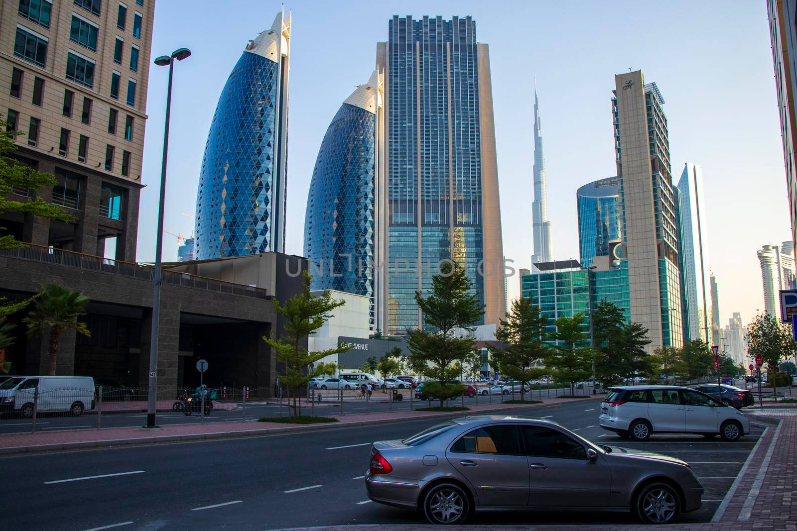 Dubai Financial Center road. Landmarks such Burj Khalifa, tallest building in the world, Index tower, Park towers and Address Sky view can be seen on the scene. Outdoors