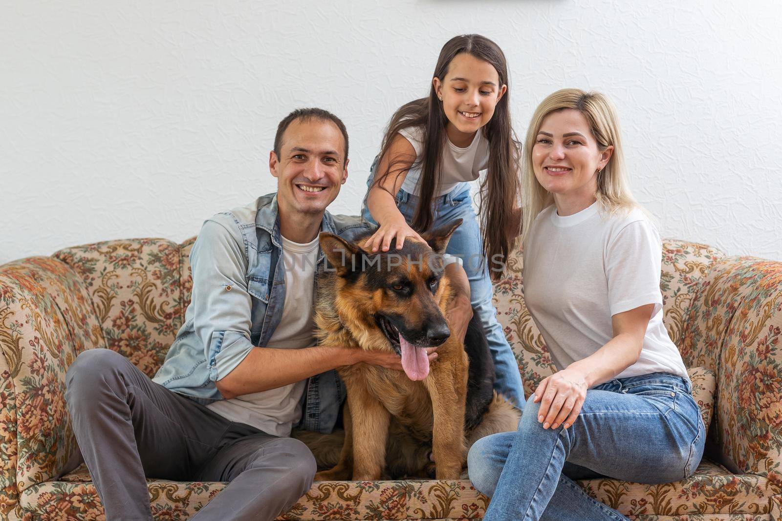 Portrait of happy family with a dog having fun together at home.