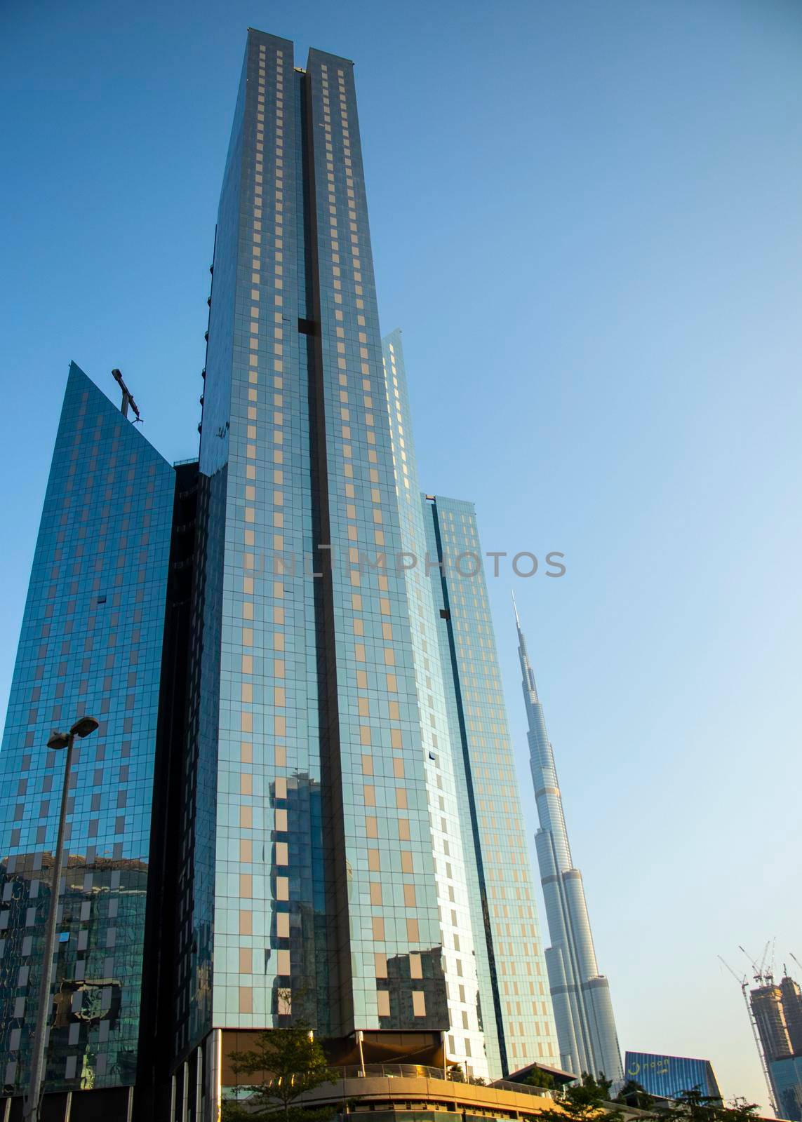 Towers in Dubai International Financial Center, Burj Khalifa, Tallest building in the world can be seen in the scene. Outdoors