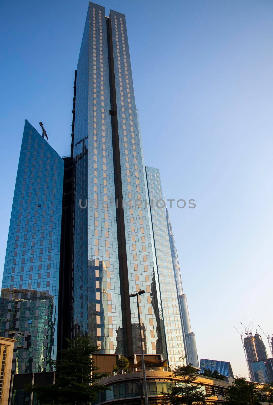 Towers in Dubai International Financial Center, Burj Khalifa, Tallest building in the world can be seen in the scene. Outdoors