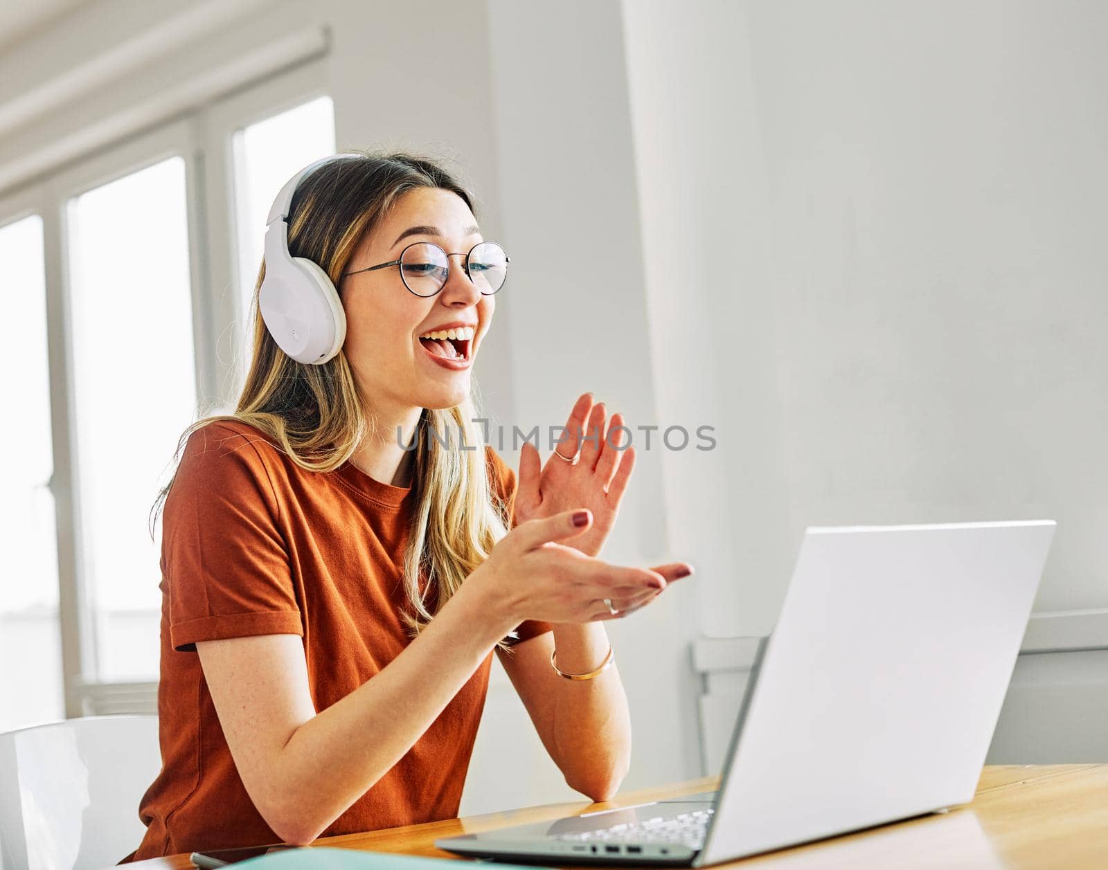 Portrait of a young beautiful woman having video call on laptop at home