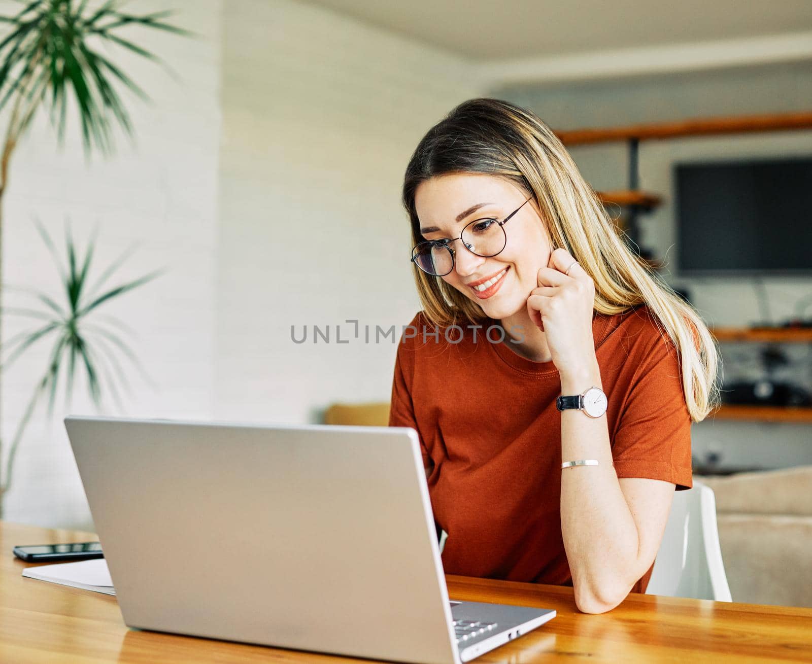 Portrait of a young girl using laptop at home