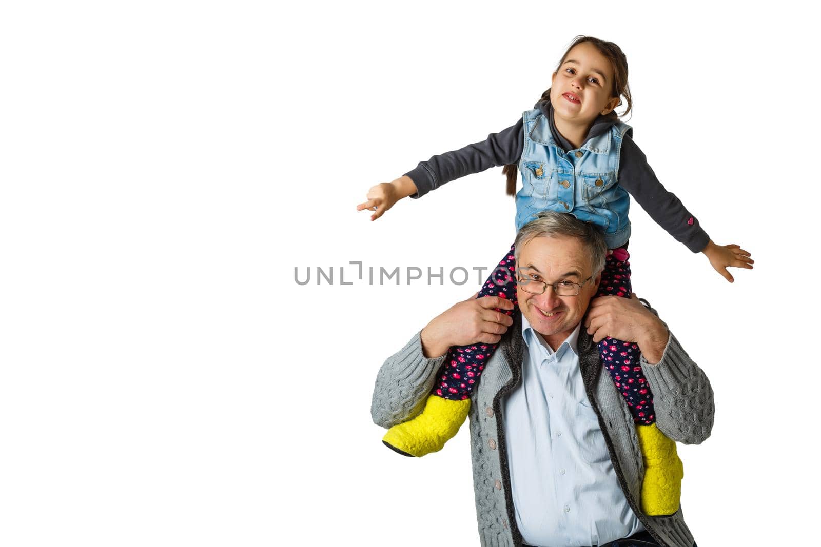 Authentic photo of smiling grandfather hugging with his granddaughter.