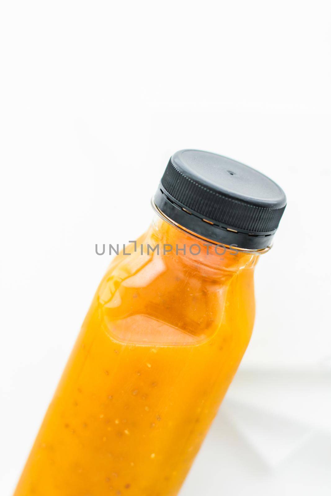 Healthy nutrition, organic drink and fasting cleanse concept - Detox fruit smoothie juice in a bottle, diet catering delivery. Isolated on white background