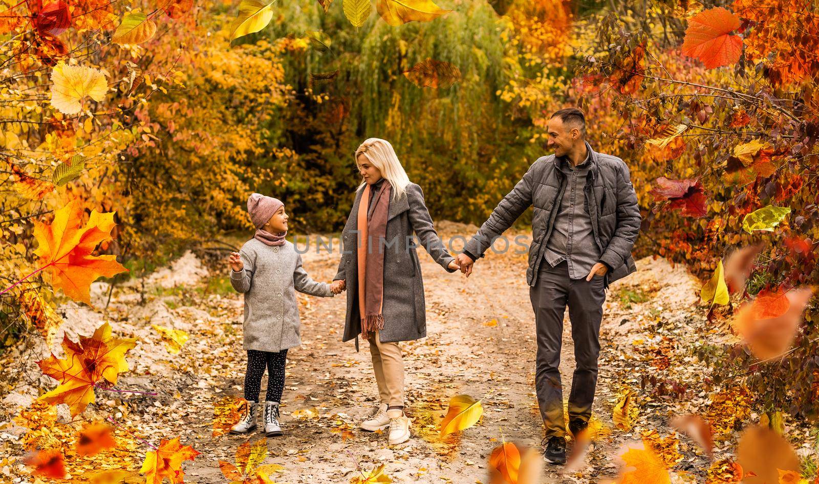 family, childhood, season and people concept - happy family playing with autumn leaves in park. High quality photo