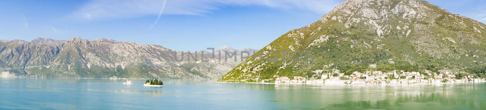 Panoramic view of Bay of Kotor from the sea surrounded by mountains in Montenegro, one of the most beautiful bay in the world.