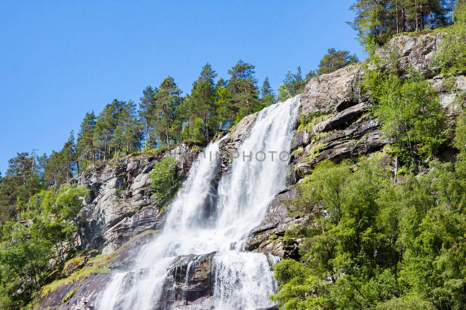 View of Tvindefossen or Tvinnefossen waterfall near Voss in Norway
