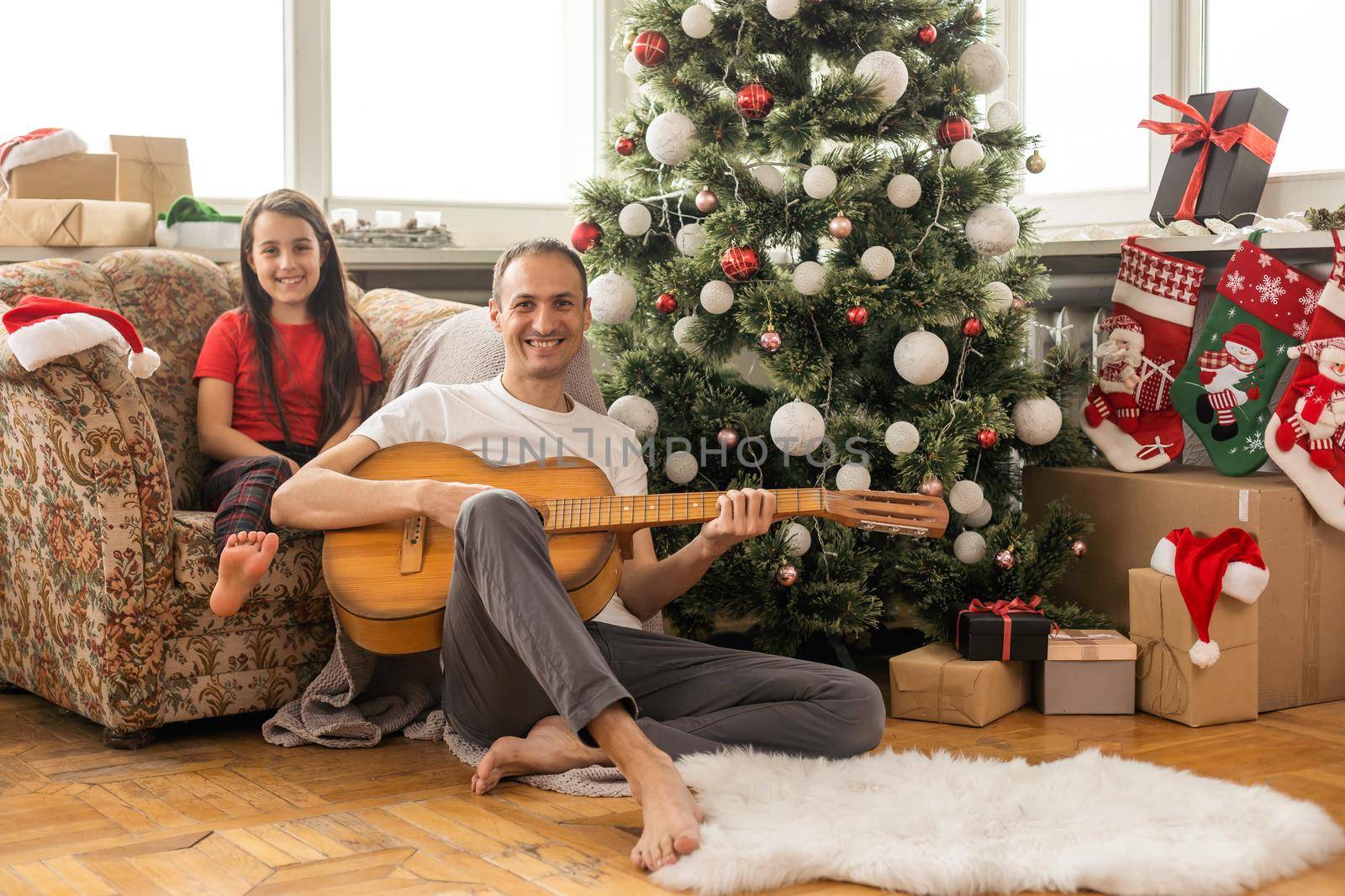 Young happy family while celebrating Christmas at home