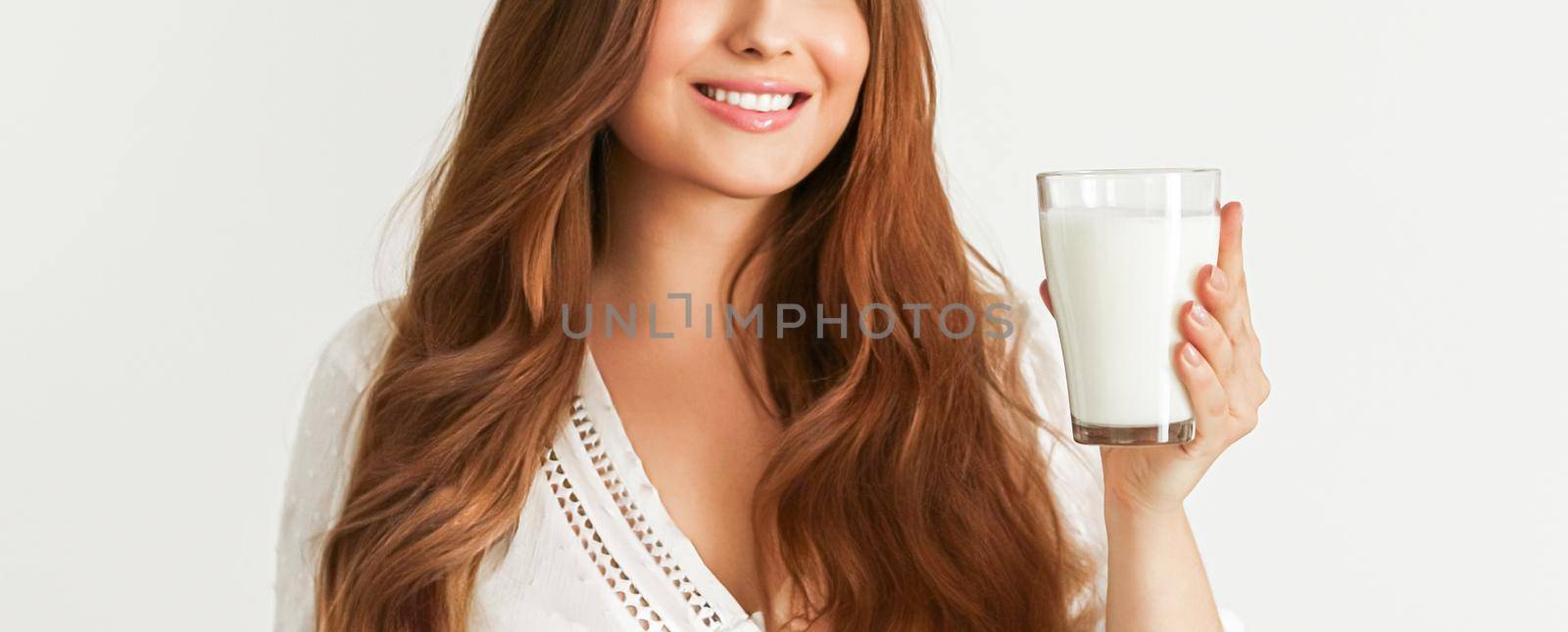 Diet, health and wellness concept, woman holding glass of milk or protein shake cocktail