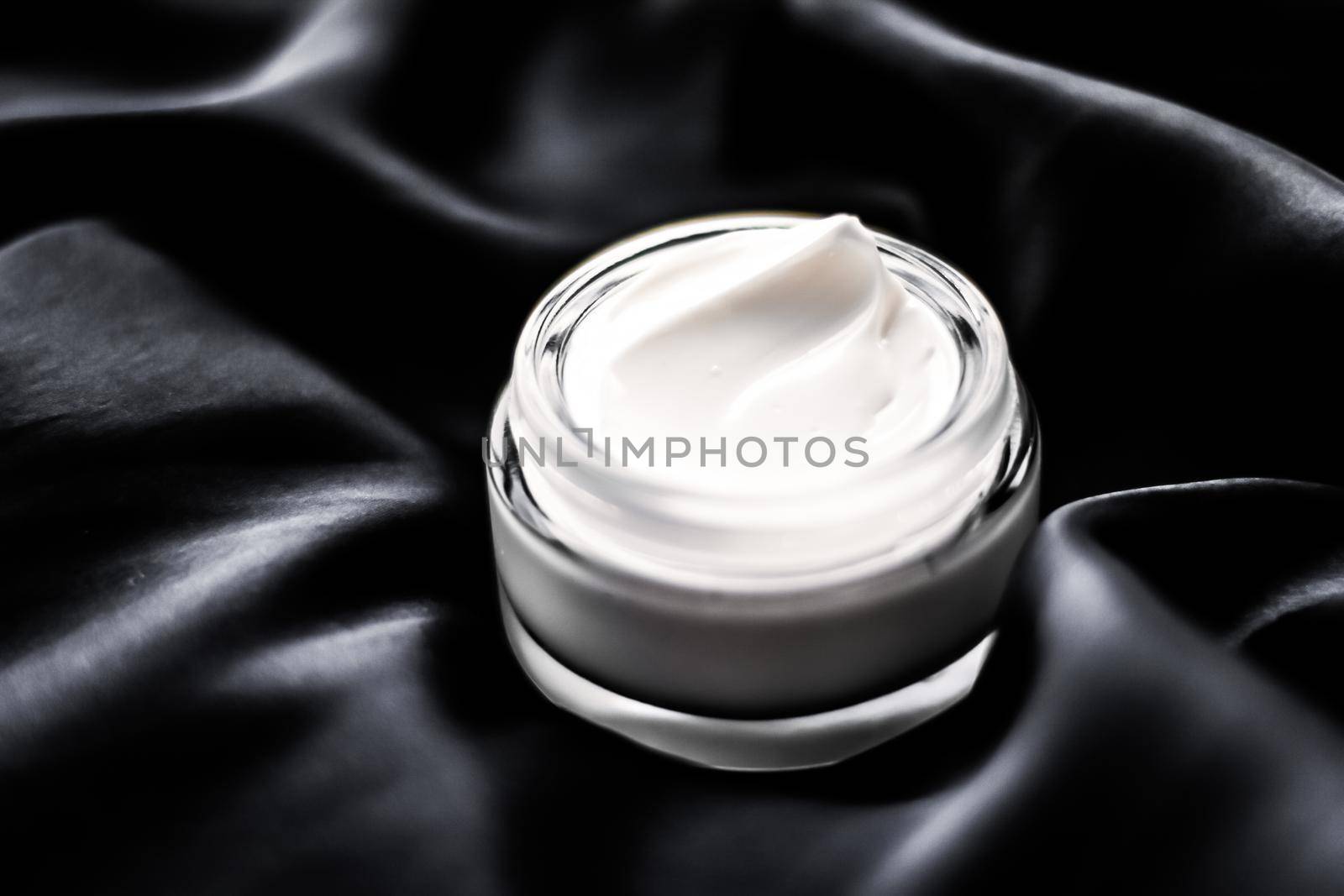 Luxury sensitive skincare moisturizing face cream on black silk background by Anneleven