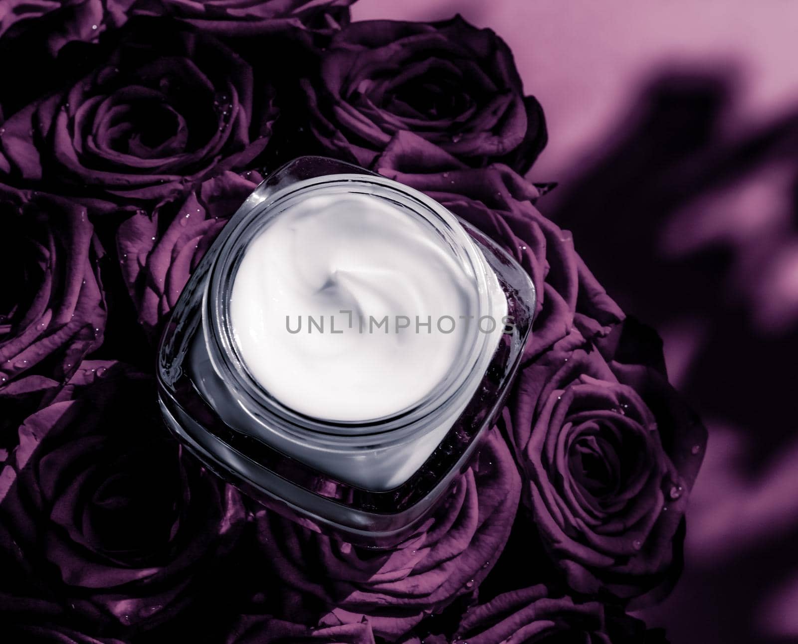 Luxe cosmetics, branding and anti-age concept - Face cream skin moisturizer on purple roses flowers, luxury skincare cosmetic product on floral background as beauty brand holiday flatlay design