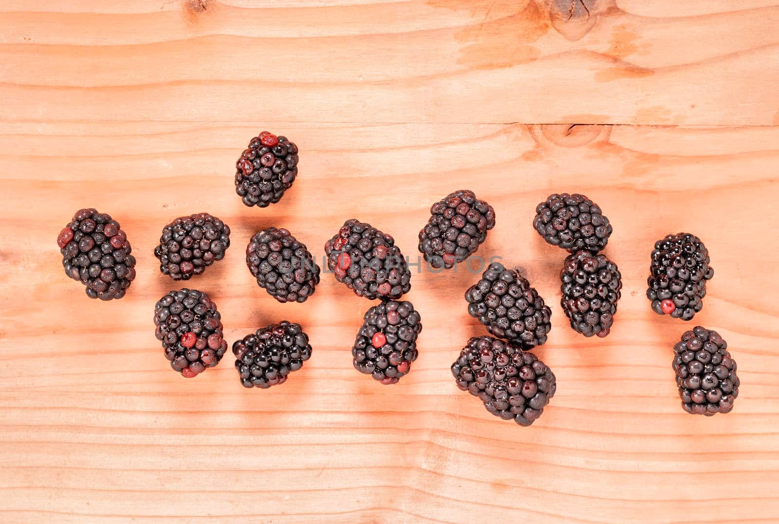 Fresh wild blackberries on wooden table , edible fruit