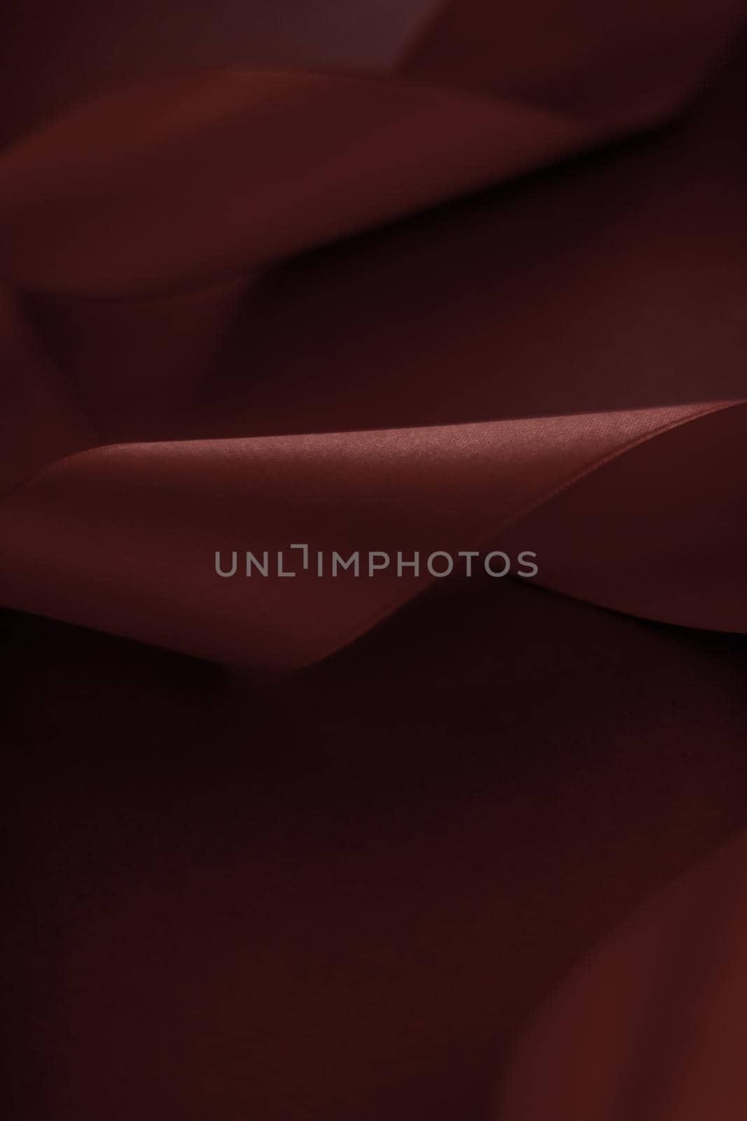 Branding, holidays and luxe brands concept - Abstract silk ribbon on chocolate background, exclusive luxury brand design for holiday sale product promotion and glamour art invitation card backdrop