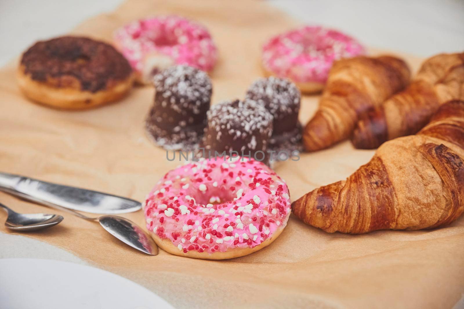 Donuts, croissants and sweets on craft paper by Viktor_Osypenko