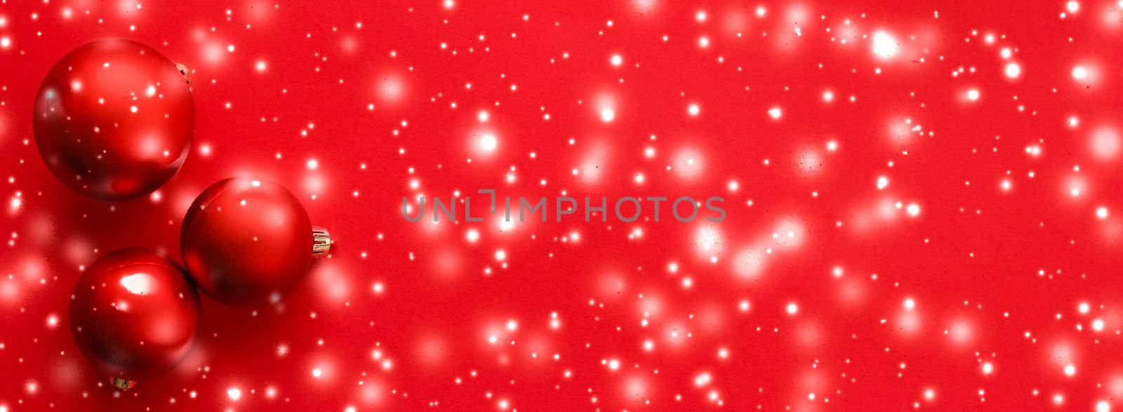 Gift decor, New Years Eve and happy celebration concept - Christmas baubles on red background with snow glitter, luxury winter holiday card