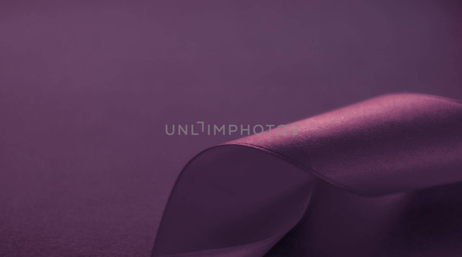 Branding, holidays and luxe brands concept - Abstract curly silk ribbon on purple background, exclusive luxury brand design for holiday sale product promotion and glamour art invitation card backdrop