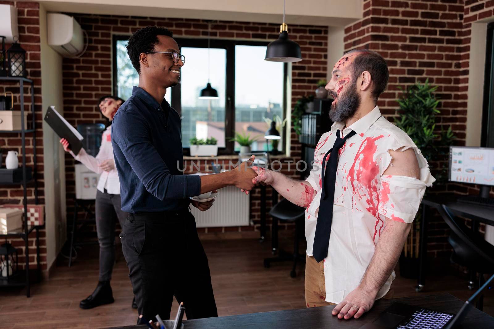 Businessman doing handshake with evil zombie by DCStudio