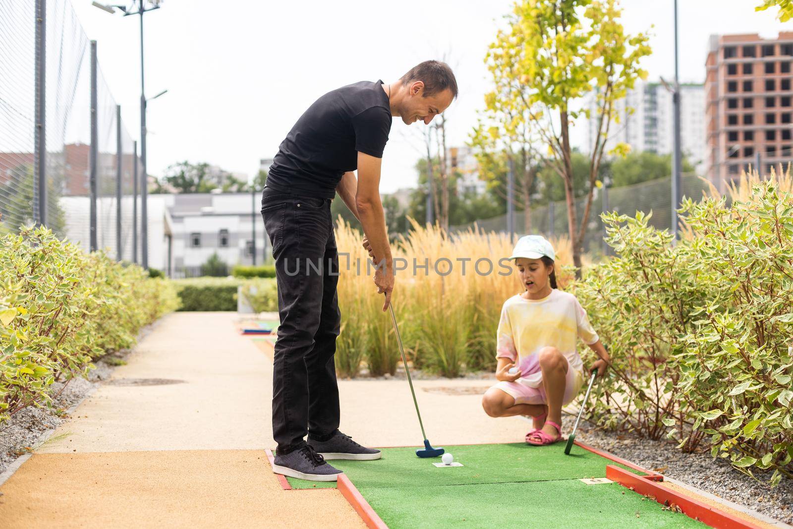 Closeup of player play mini golf with ball.