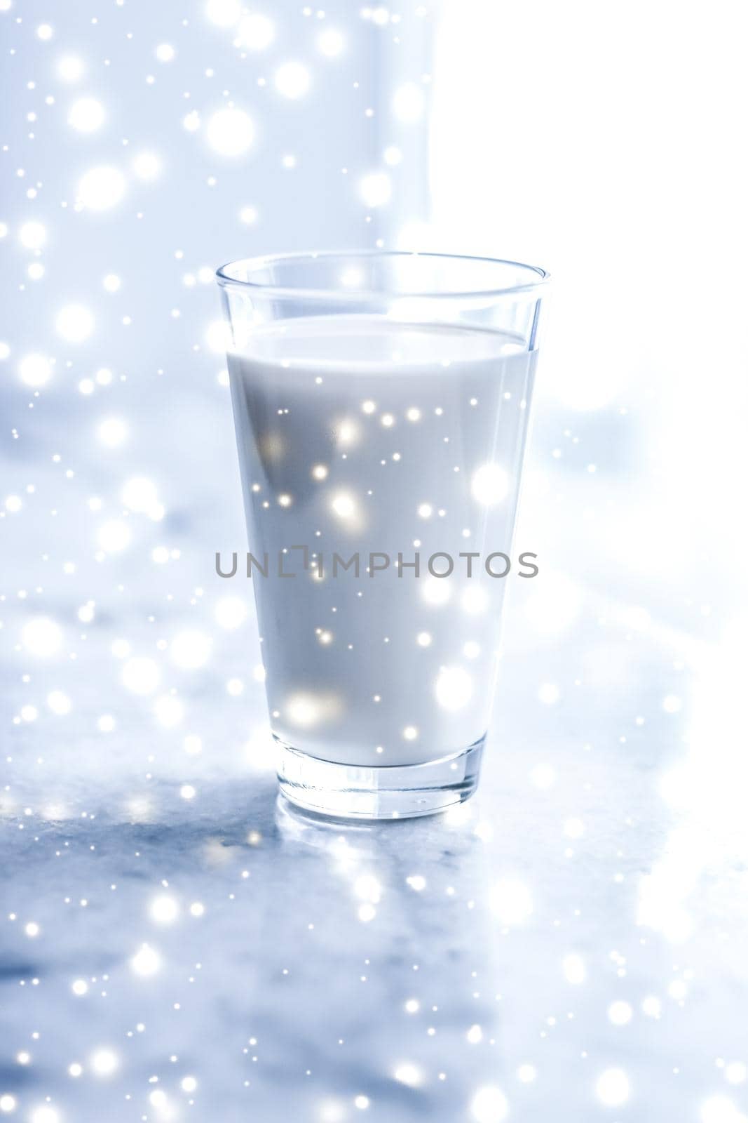 Magic holiday drink, pouring organic lactose free milk into glass on marble table by Anneleven