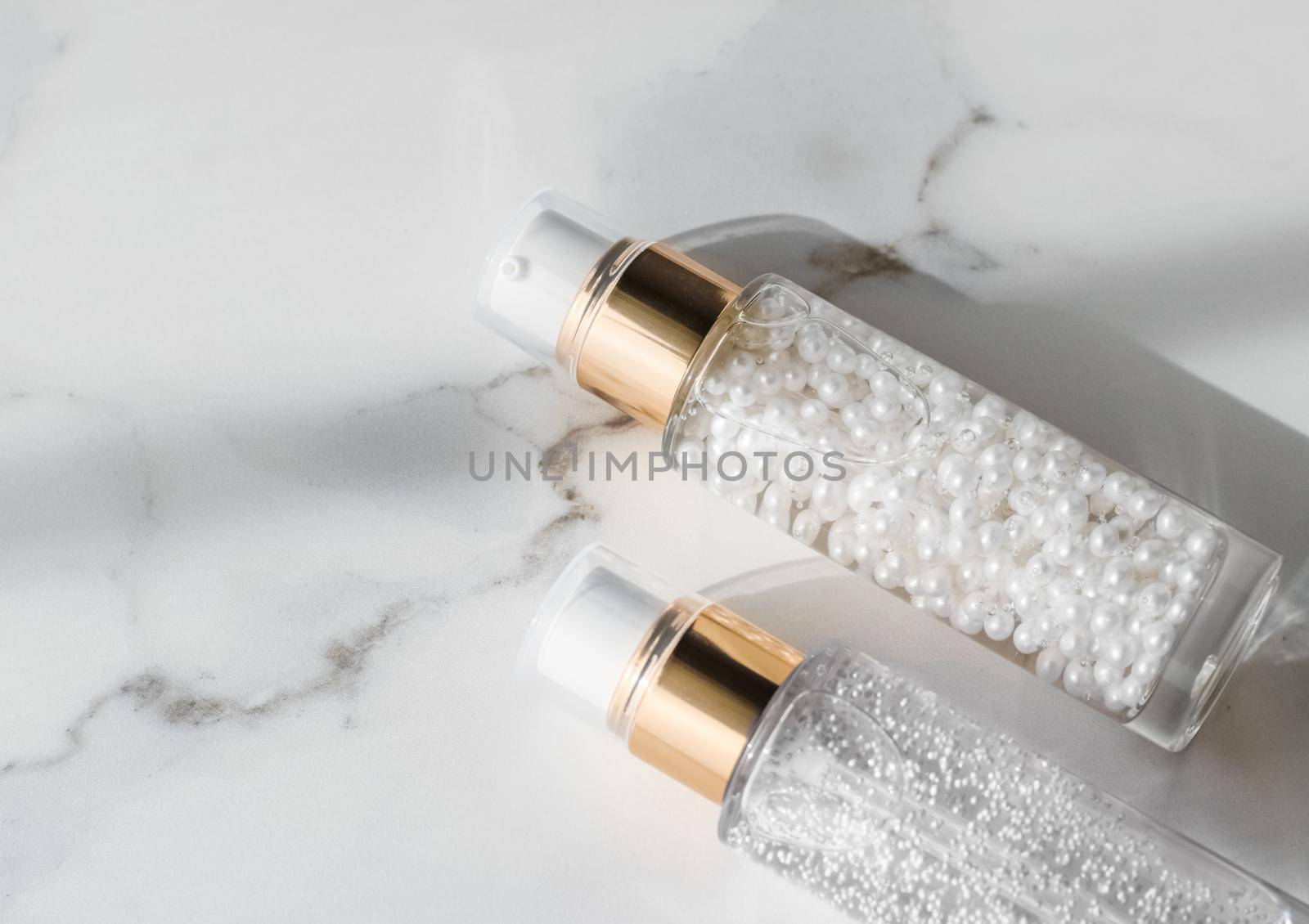 Cosmetic branding, packaging and make-up concept - Skin care serum and gel bottle, moisturizing lotion and lifting cream emulsion on marble, anti-age cosmetics for luxury beauty skincare brand design
