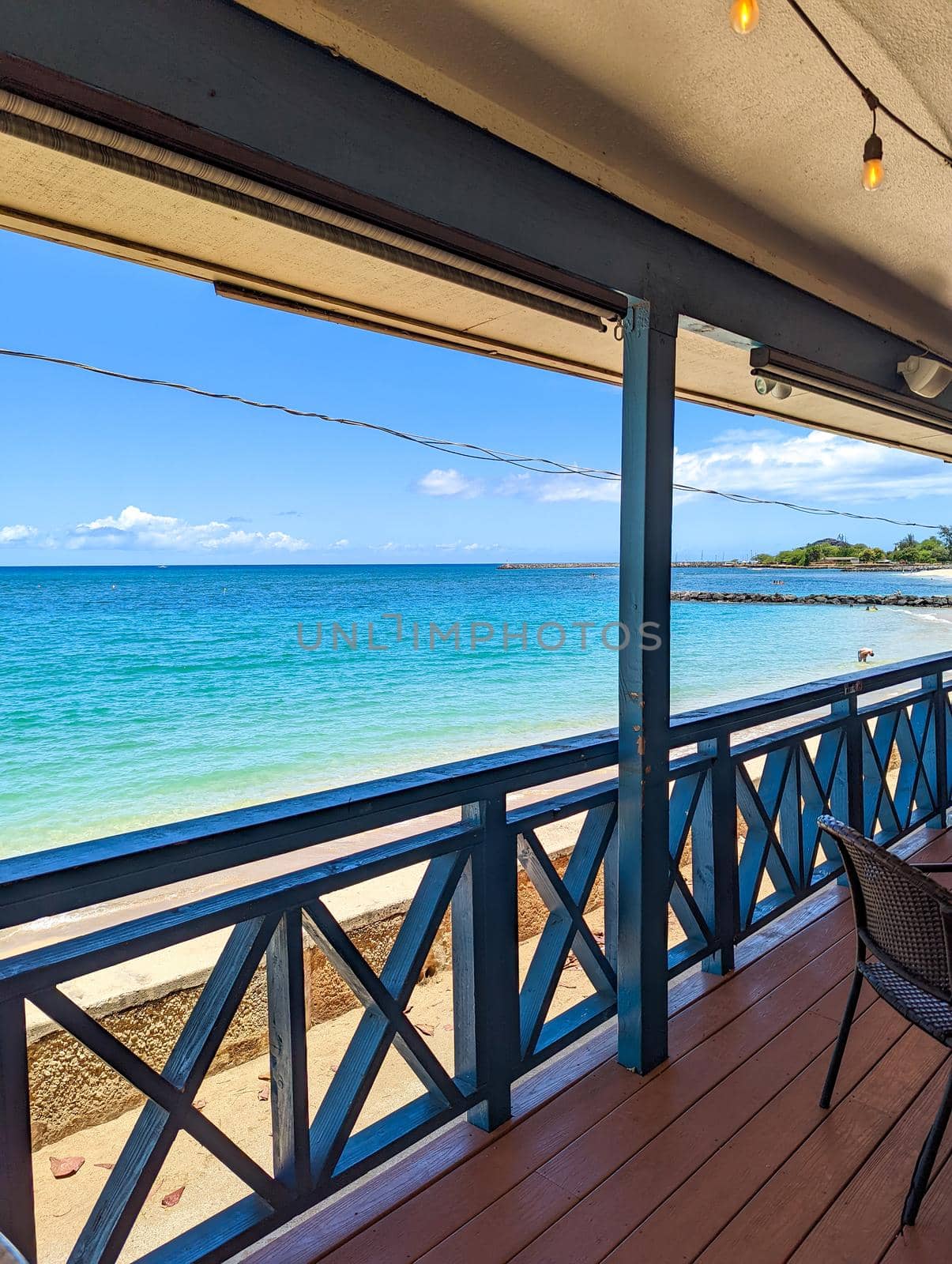 enjoying a dringk and a view of beach in oahu hawaii