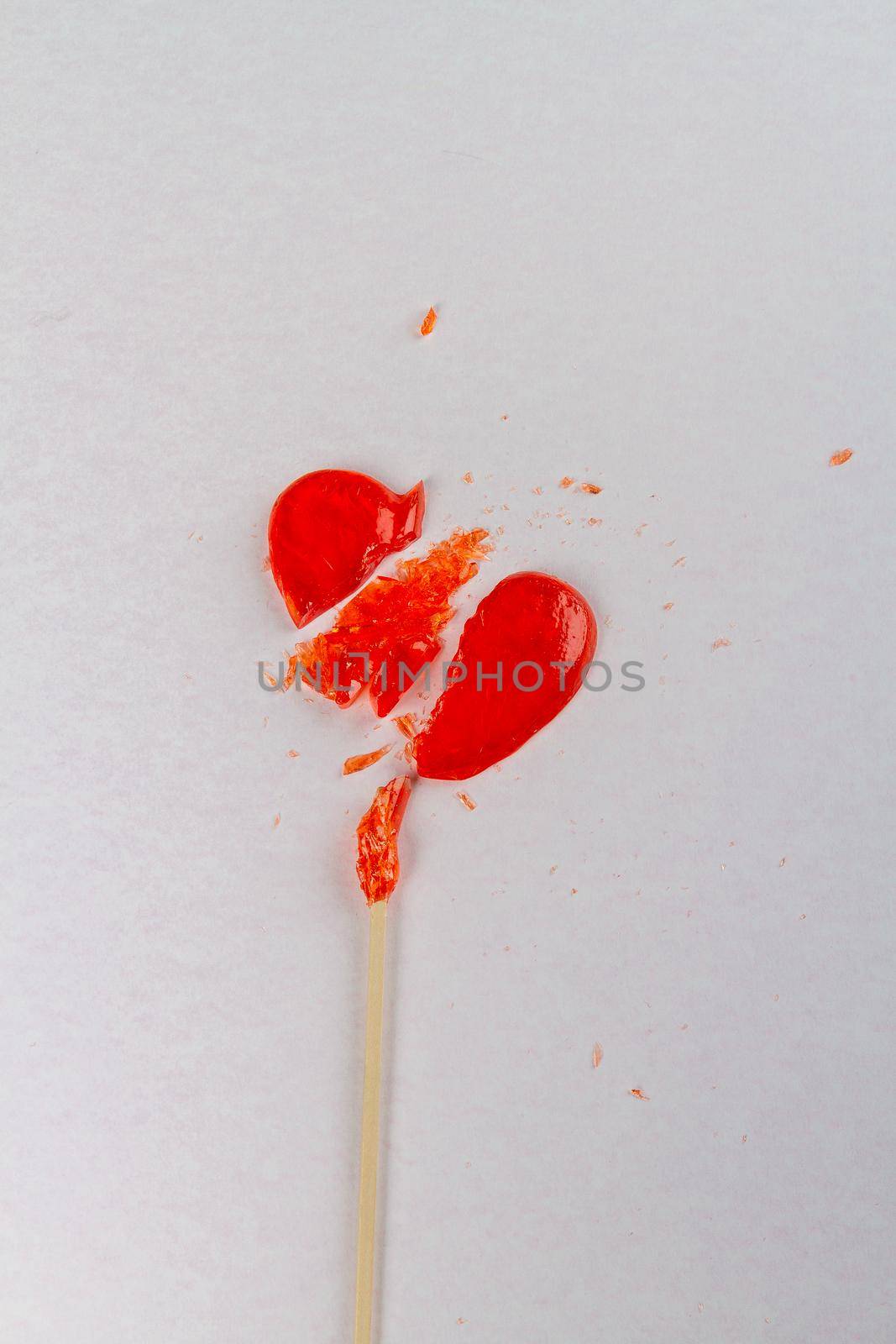 Vertical shot of broken heart shaped lollipop. by super_picture