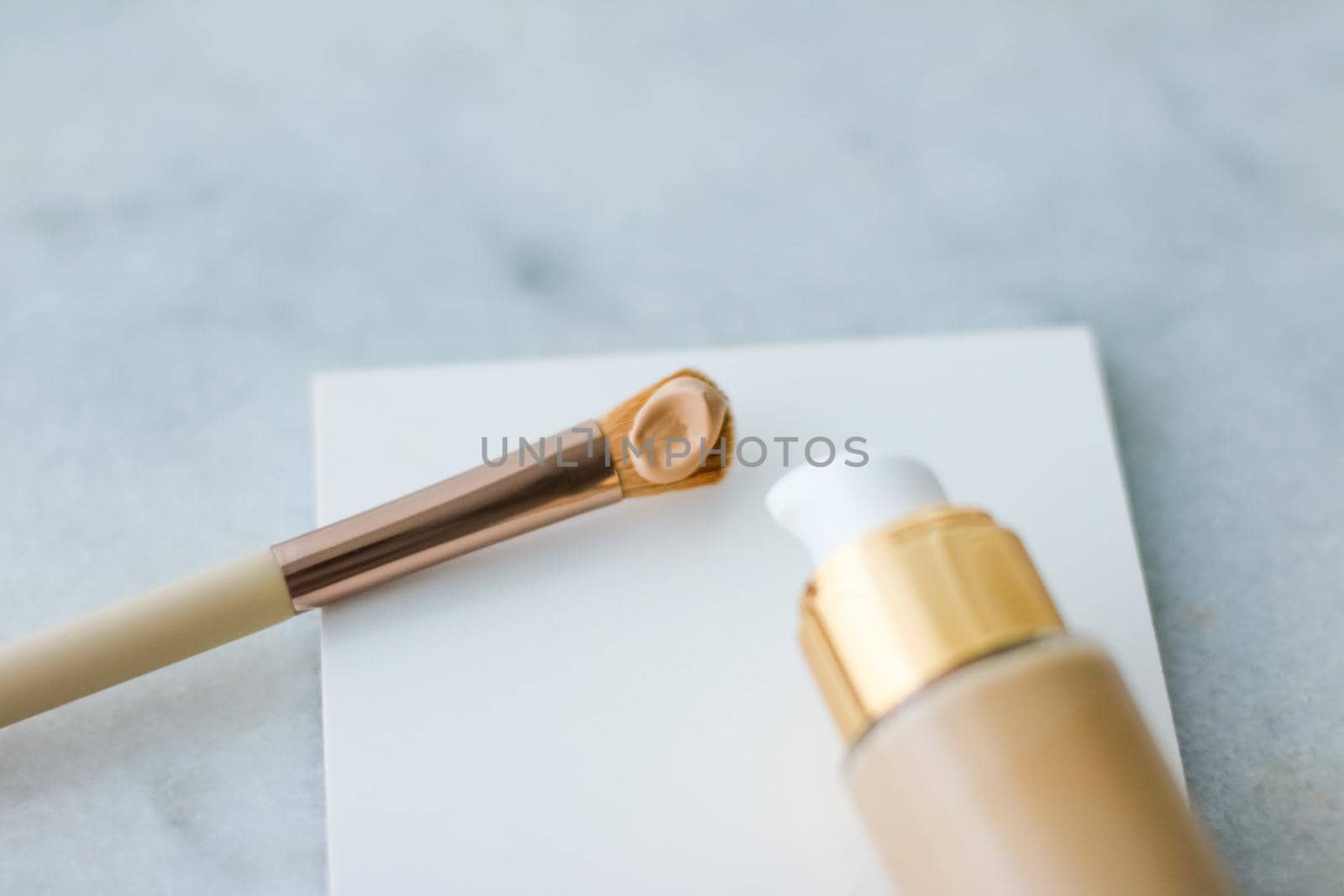 Cosmetic branding, glamour and skincare concept - Makeup foundation bottle and contouring brush on marble, make-up concealer bb cream as cosmetics product for luxury beauty brand holiday design
