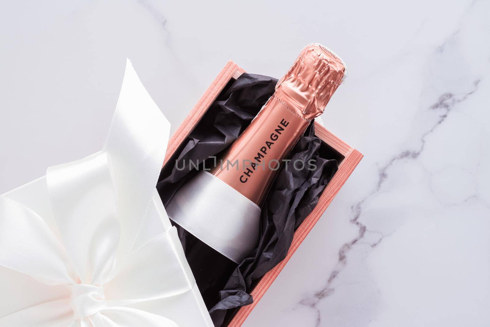 Champagne bottle and gift box on marble, New Years, Christmas, Valentines Day or wedding holiday present and luxury product packaging for beverage brand by Anneleven