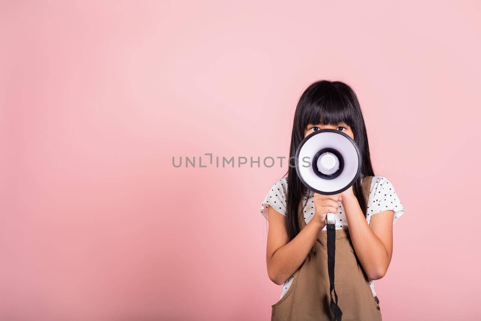 Asian little kid 10 years old shouting by megaphone by Sorapop