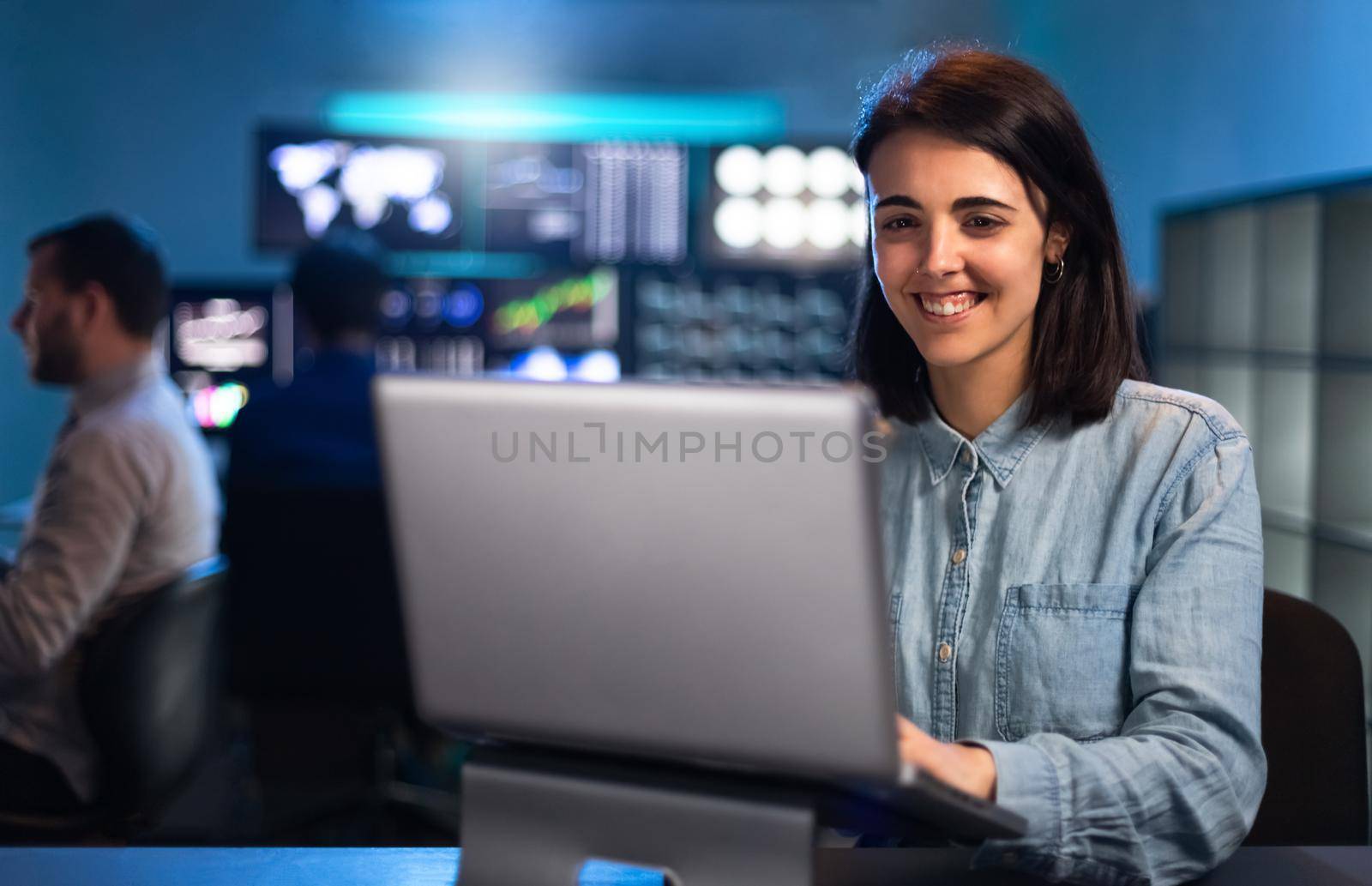 Happy woman working in the office using laptop. Financial analyst, trader and stock market. Copy space. Business concept.