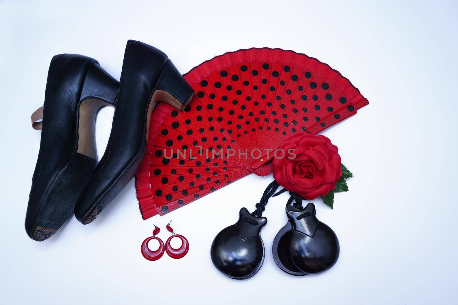 objects used in flamenco fan, castanets, high heel shoes and earrings on a white background