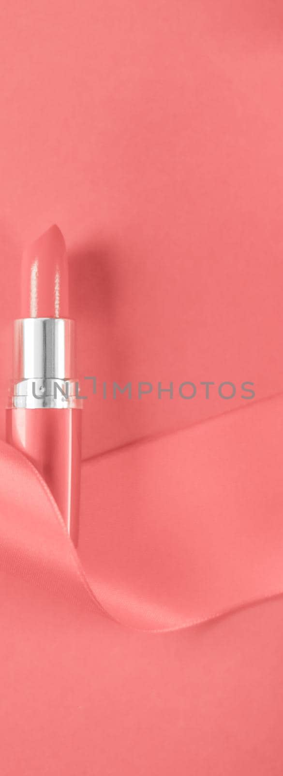 Luxury lipstick and silk ribbon on coral holiday background, make-up and cosmetics flatlay for beauty brand product design by Anneleven