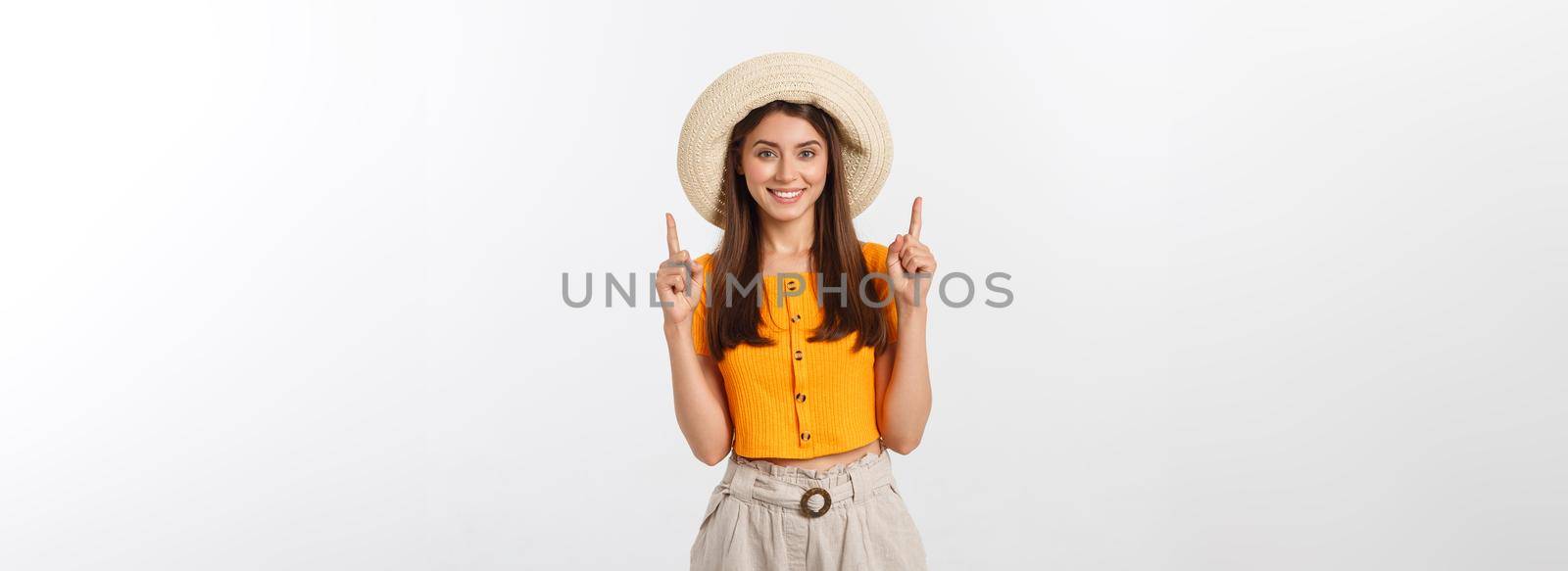 Teenager girl on summer vacation surprised and pointing finger on copy space over isolated white background. by Benzoix