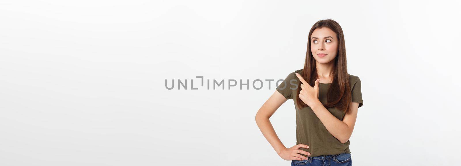 Portrait happy and surprised young lady standing isolated over grey background. Looking camera pointing. by Benzoix