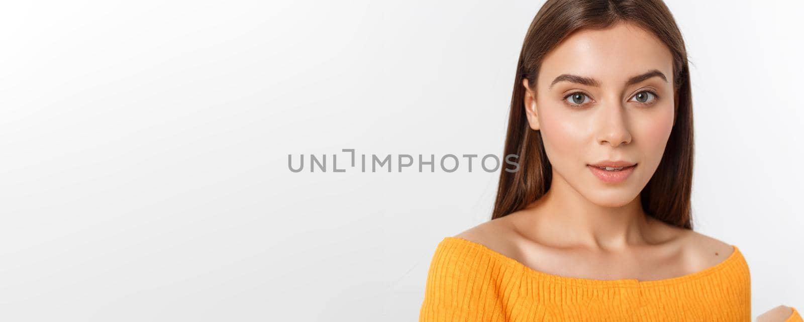 friendly smiling young woman with beatiful face portrait studio shot.