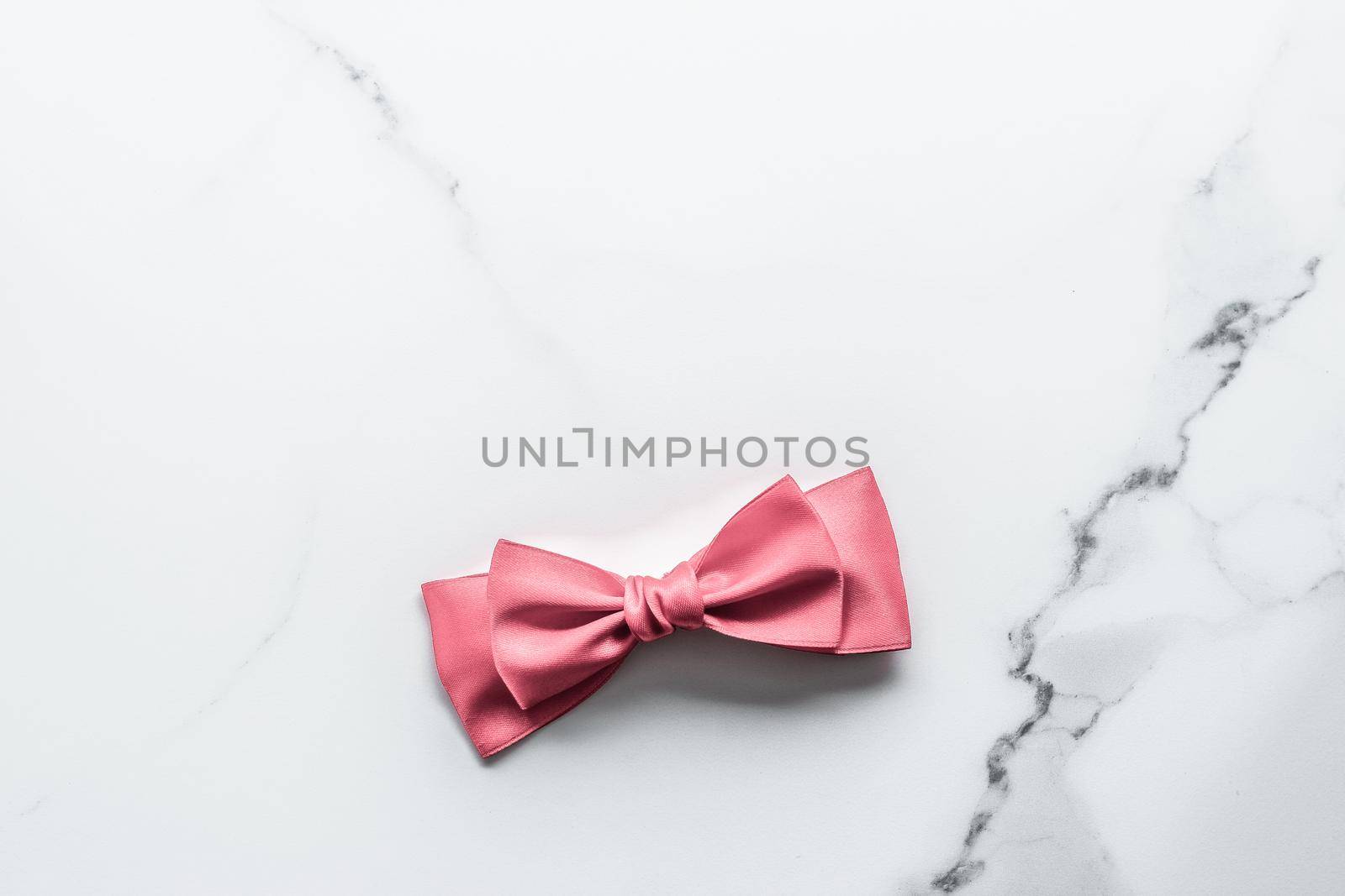Birthday, wedding and girly branding concept - Coral silk ribbon and bow on marble background, girl baby shower present and glamour fashion gift decor for luxury beauty brand, holiday flatlay design