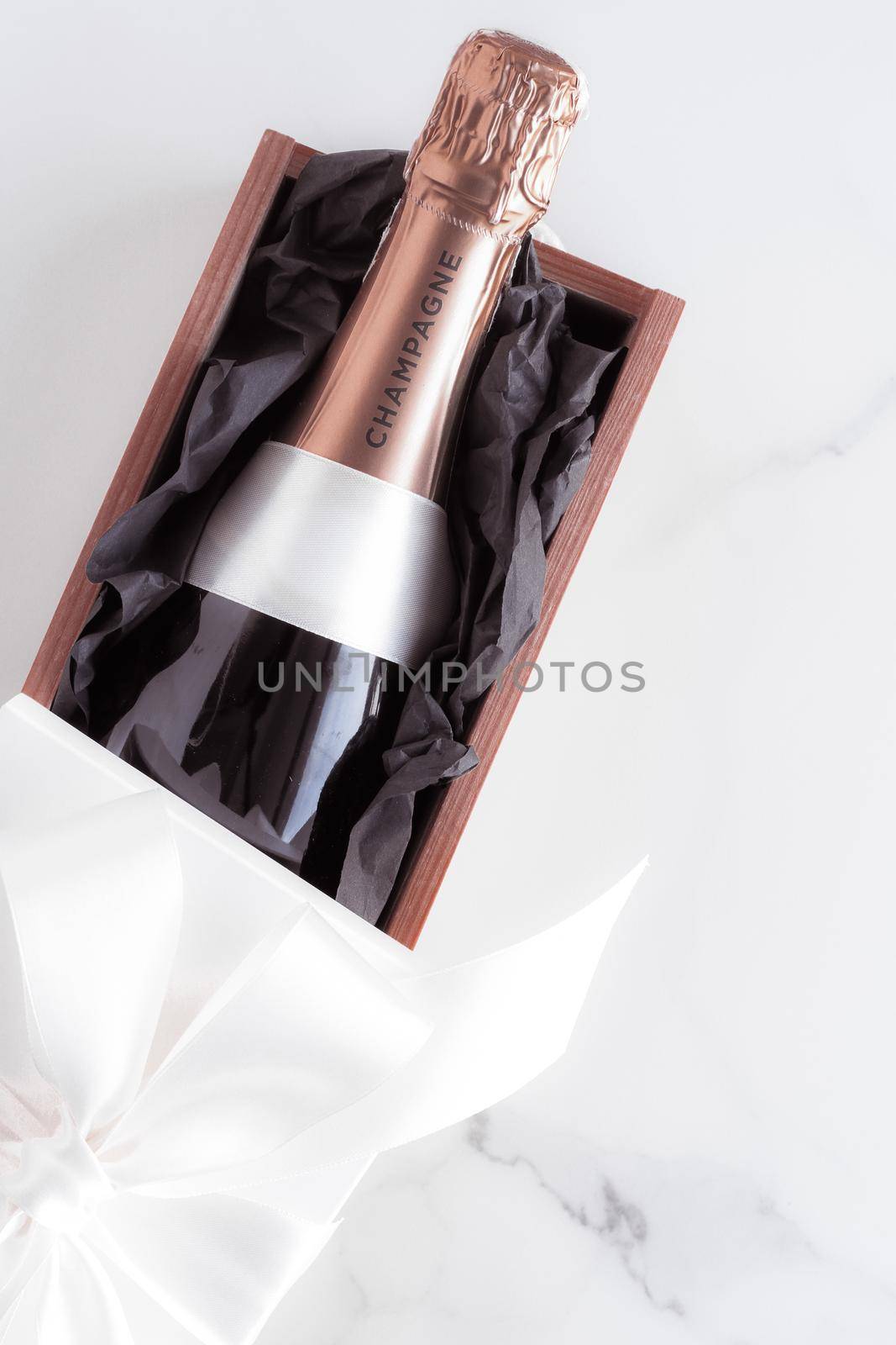 Celebration, drink and branding concept - Champagne bottle and gift box on marble, New Years, Christmas, Valentines Day or wedding holiday present and luxury product packaging for beverage brand