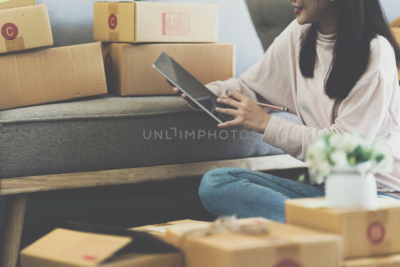 Asian SME business woman working at home office. online shopping concept.