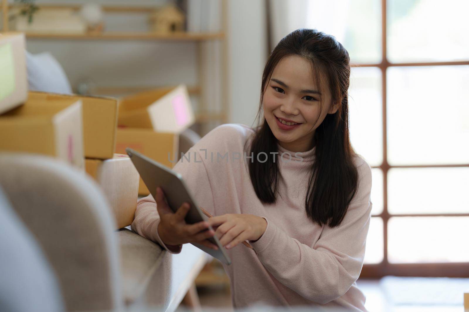 Asian SME business woman working at home office. online shopping concept.