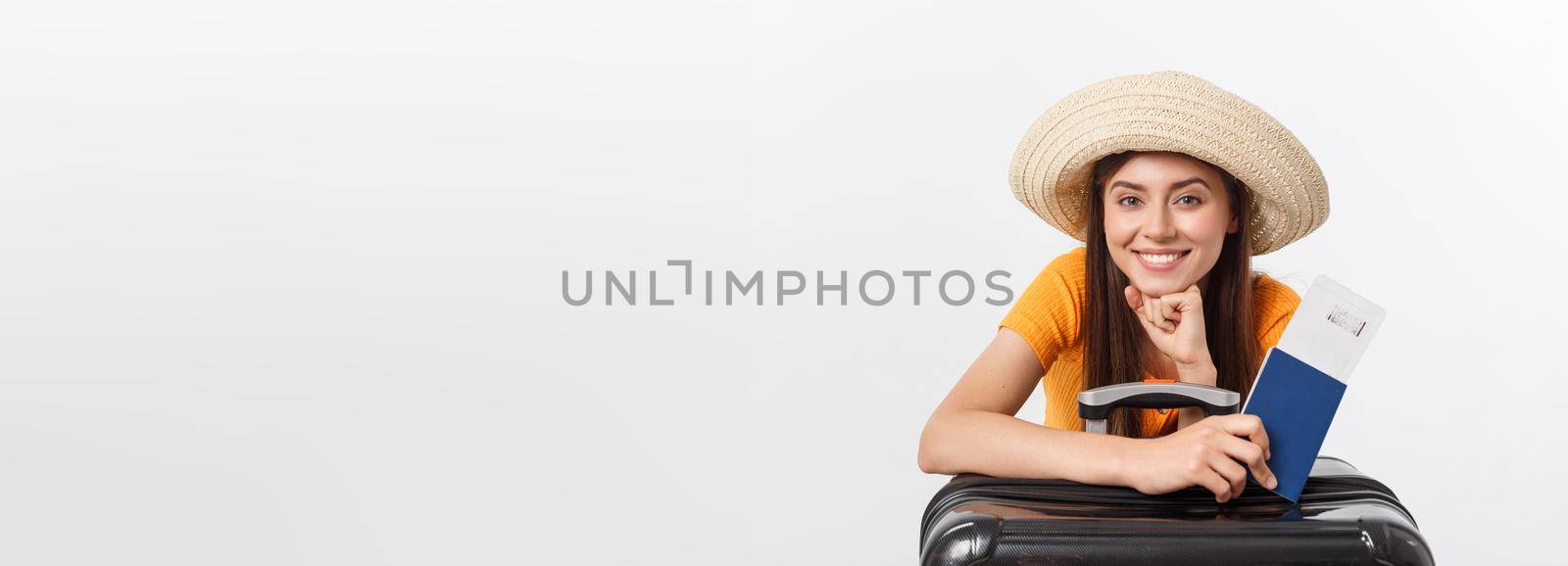 Travel concept. Studio portrait of pretty young woman holding passport and luggage. Isolated on white by Benzoix