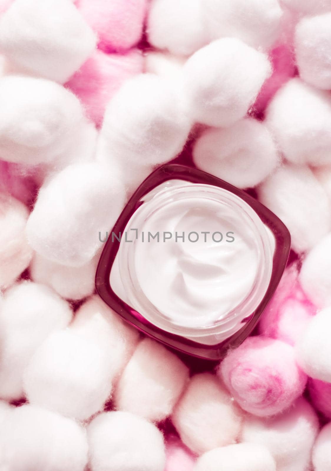 Luxury face cream for sensitive skin and pink cotton balls on background, spa cosmetics and natural skincare beauty brand product by Anneleven