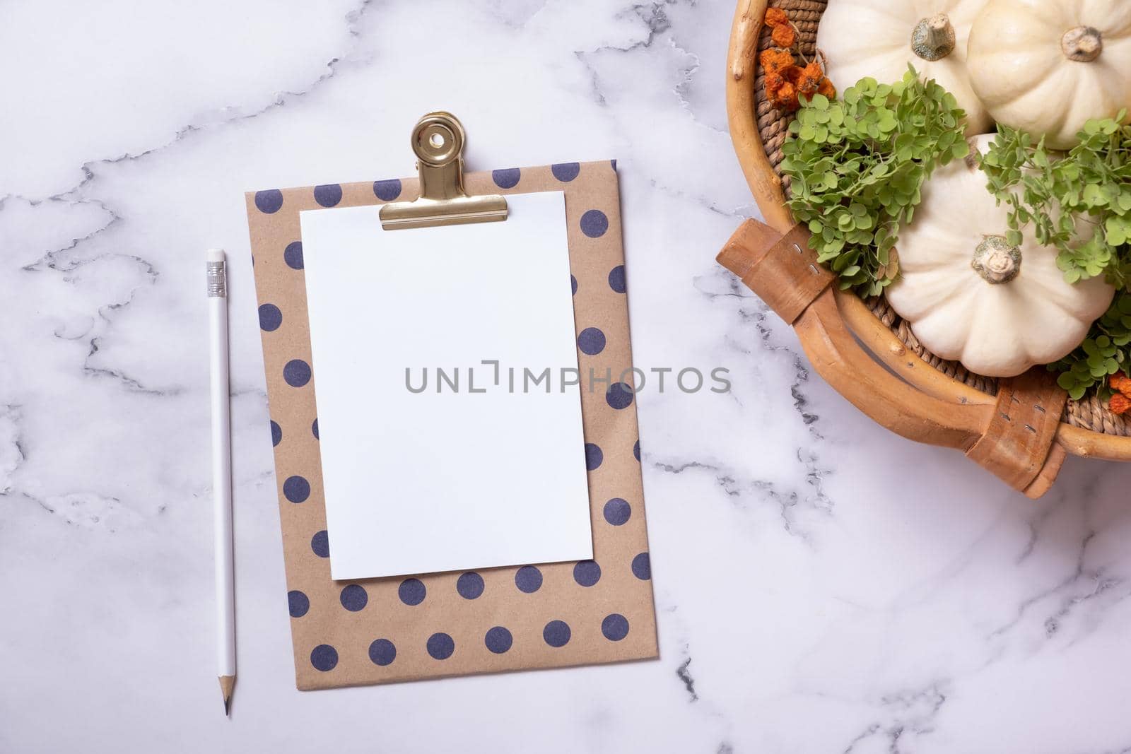 Autumn flat lay with blank tablet and decorative pumpkins on marble background top view.