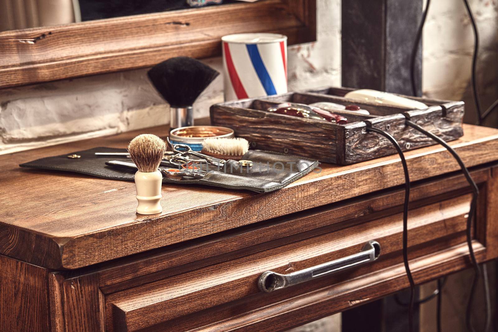 Hairdresser tools on wooden background. Top view on wooden table with scissors, comb, hairbrushes and hairclips, trimmer. Barbershop, manhood concept