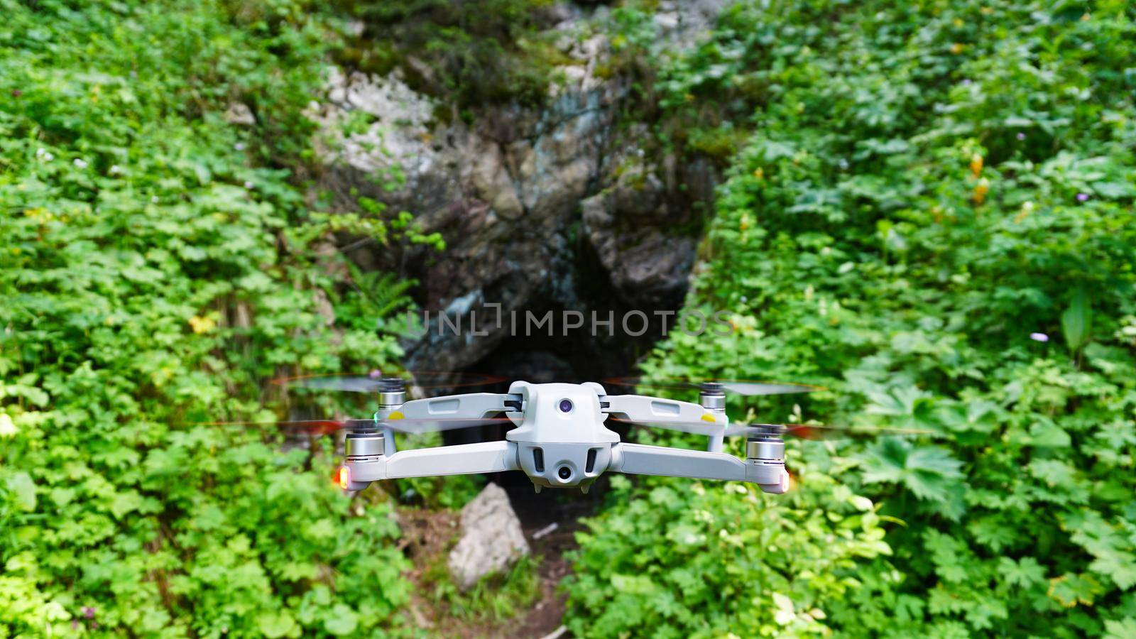 Quadcopter on the background of green rocky gorge by Passcal