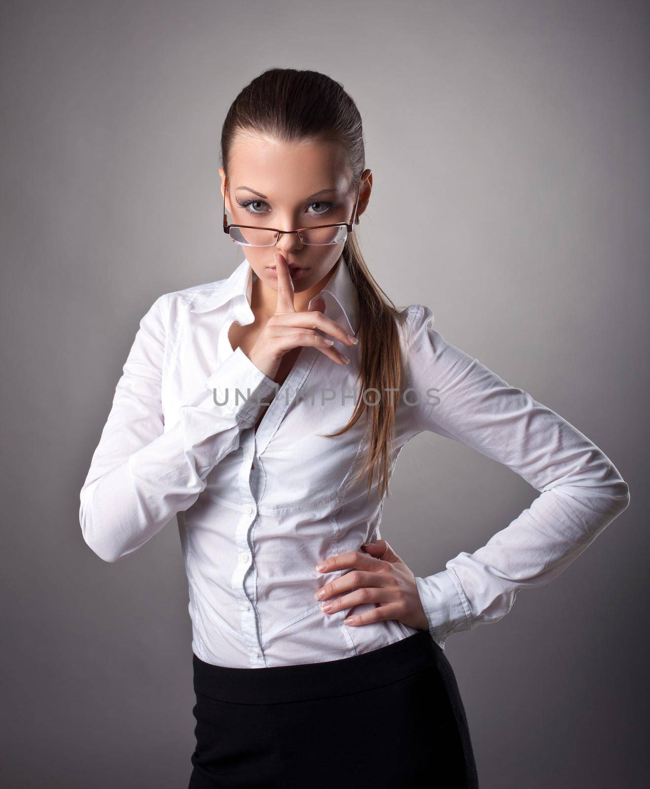 Sexy business woman silence sign look at camera
