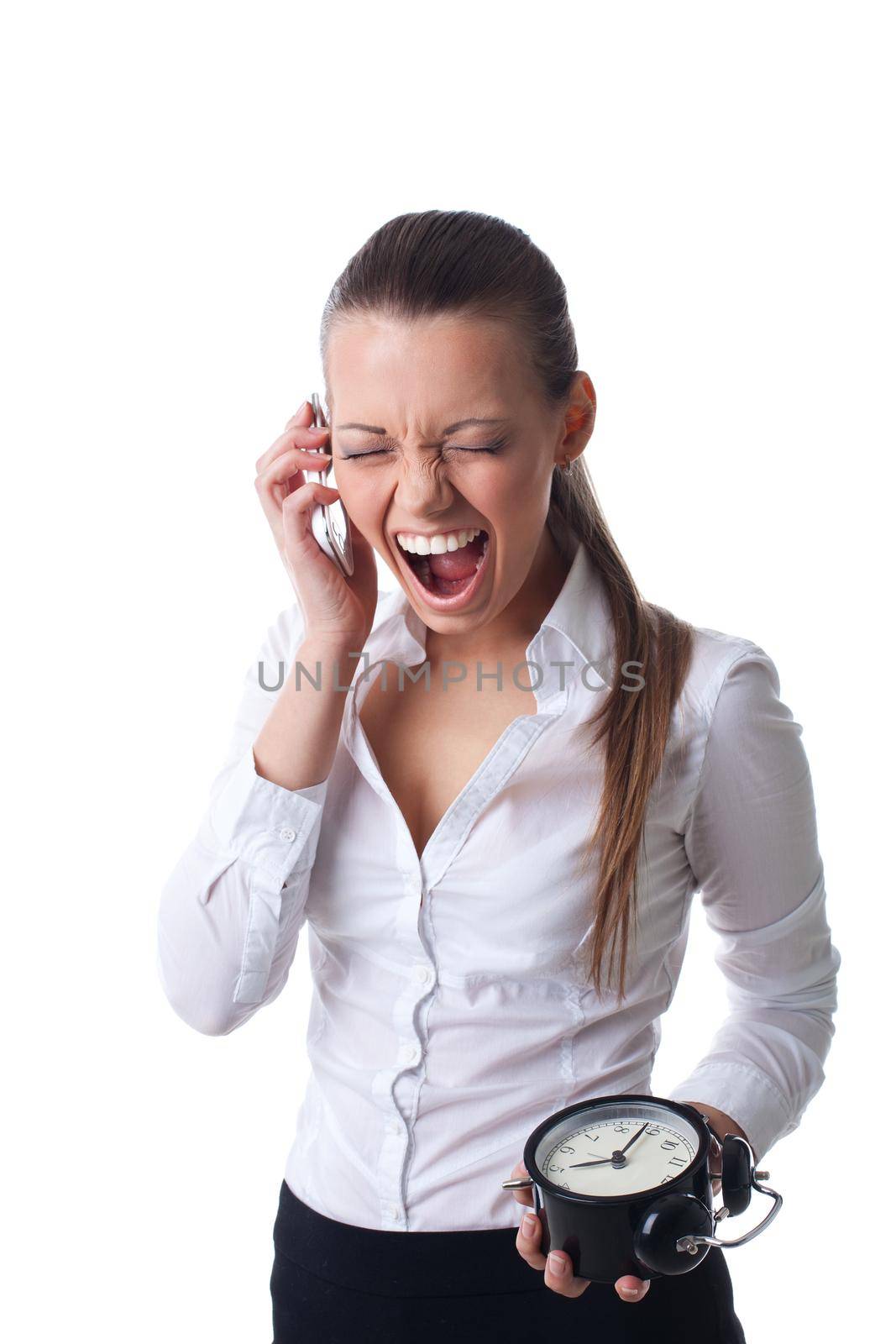 Sexy young business woman scream on cell phone with clock isolated