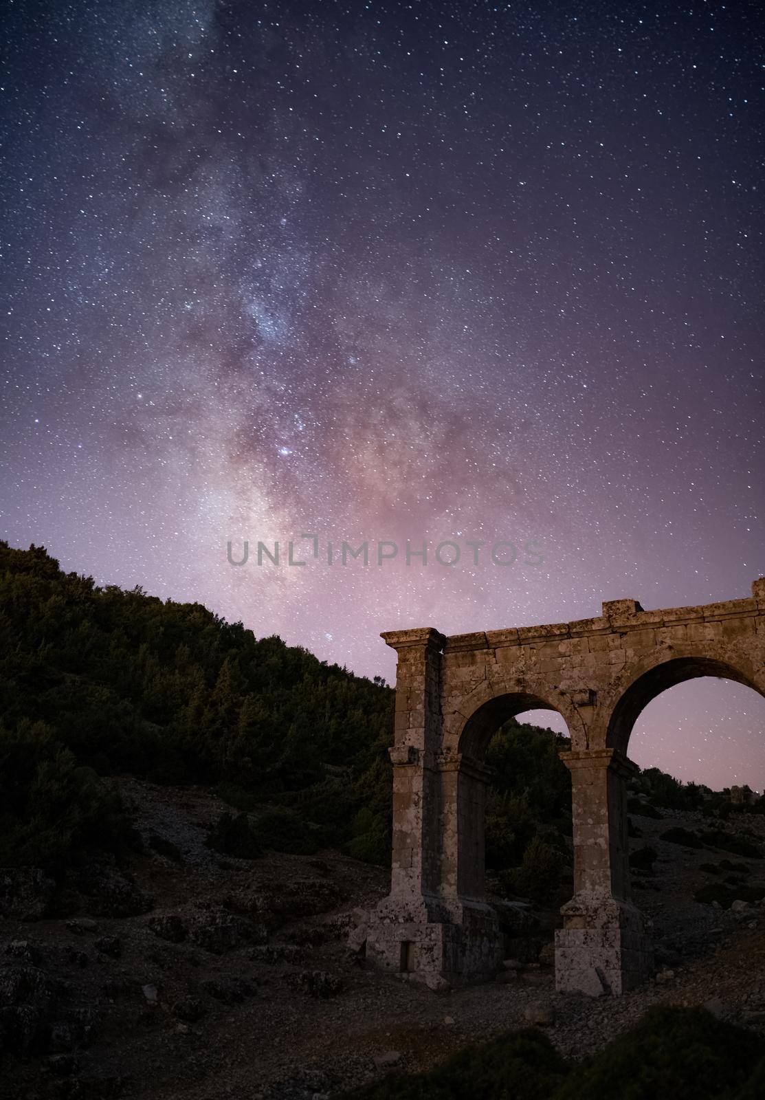 The ancient city of Ariassos, the city gate in a night when the Milky Way is visible