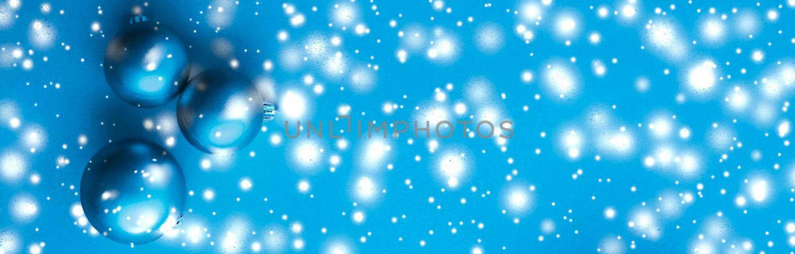 Christmas baubles on blue background with snow glitter, luxury winter holiday card by Anneleven